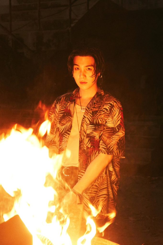 August D standing in front of a fire
